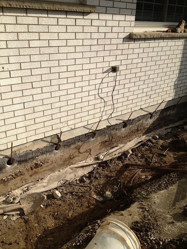 A house's exterior foundation exposed in preparation for a waterproofing & wall leak repair job by the Pro Seal team in the St. Catharines, Welland & Niagara Falls region.