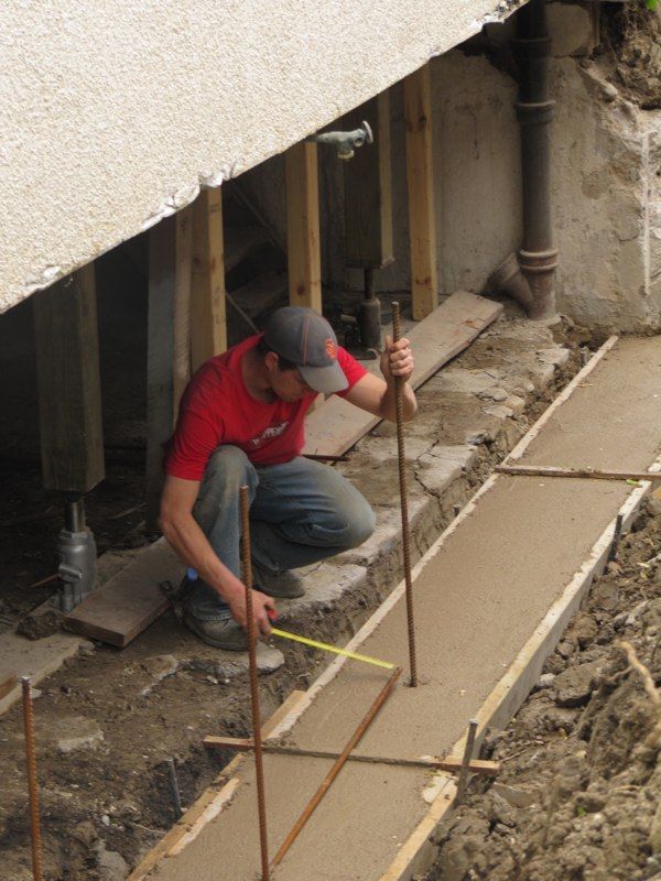 A member of the Pro Seal Waterproofing team hard at work on a house's basement foundation repair in the Niagara, Welland & St. Catharines area.