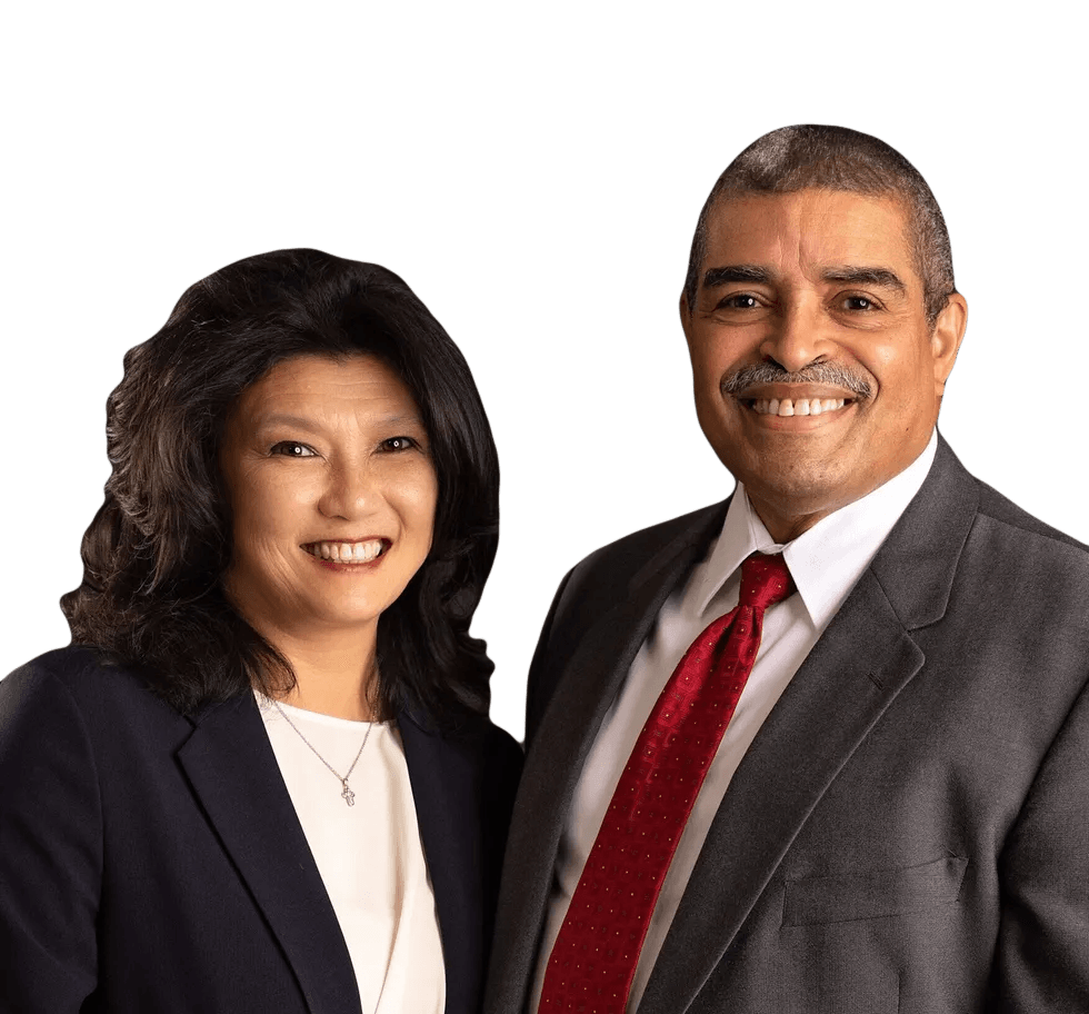 A man and a woman are posing for a picture and smiling for the camera.