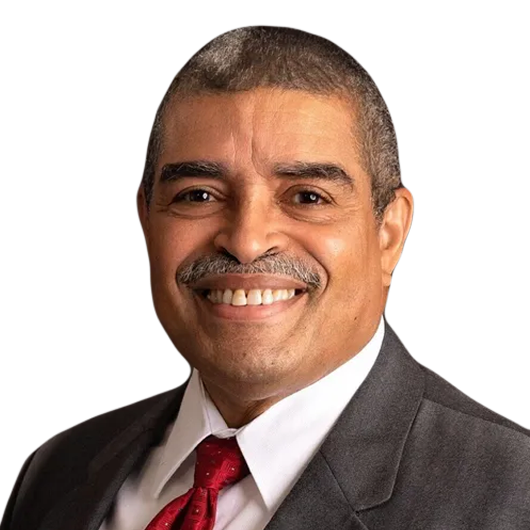 A man in a suit and tie is smiling for the camera