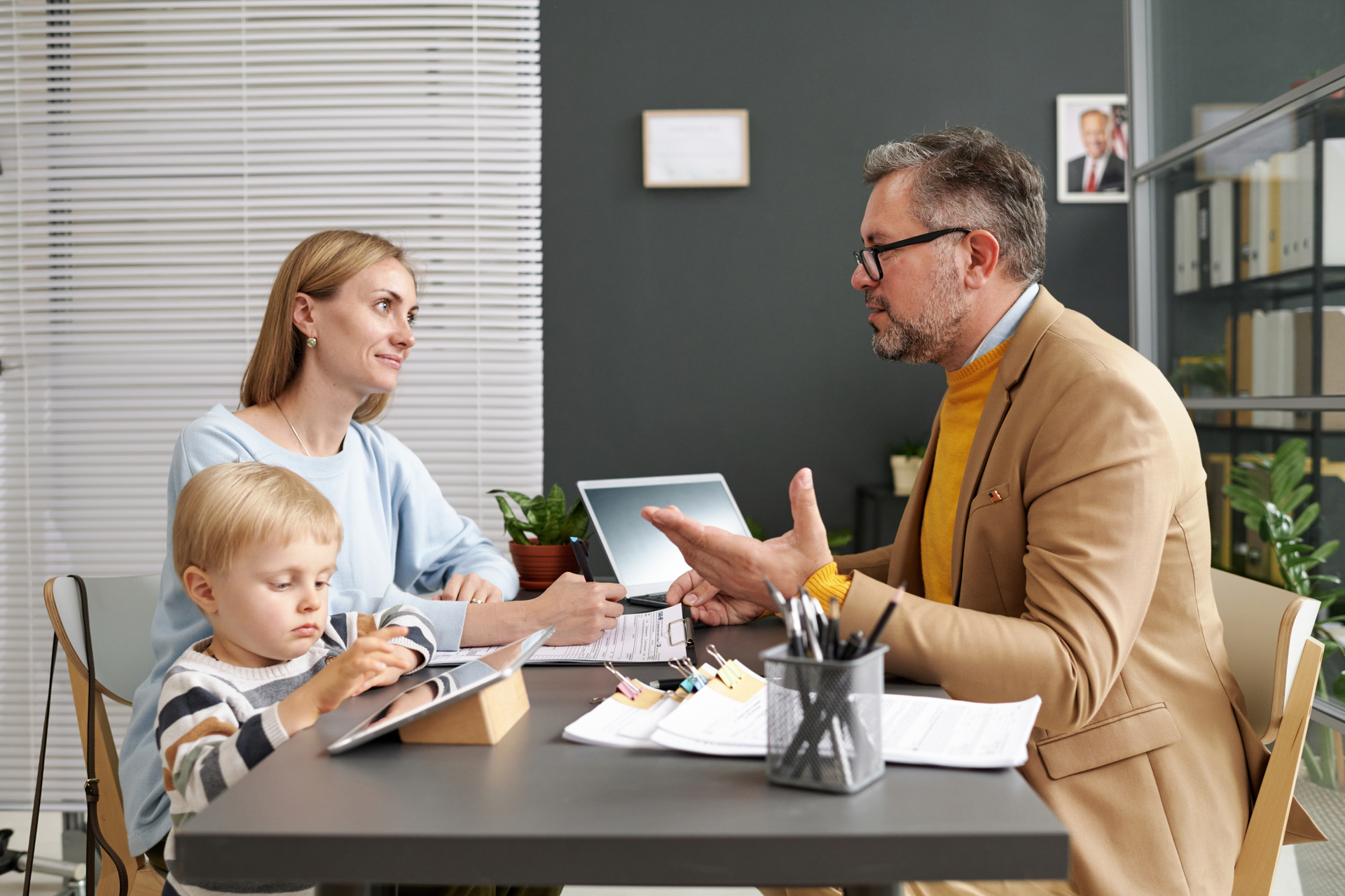 A man and a woman are sitting at a table with a child.
