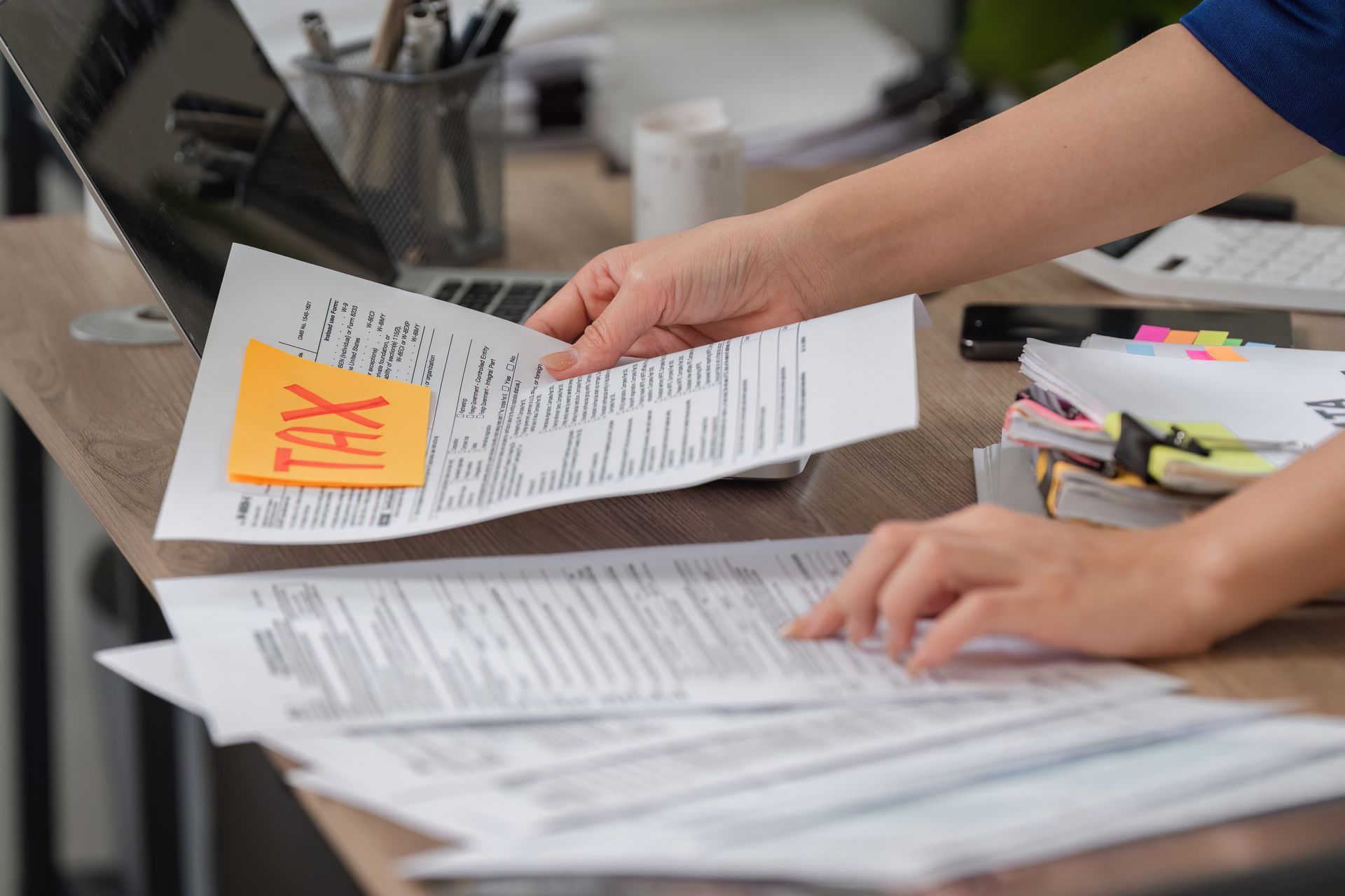 Organizing tax documents while preparing for filing and calculations.