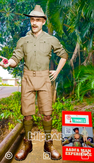A man in a safari outfit is standing next to a sign that says ' aadha man experience '.