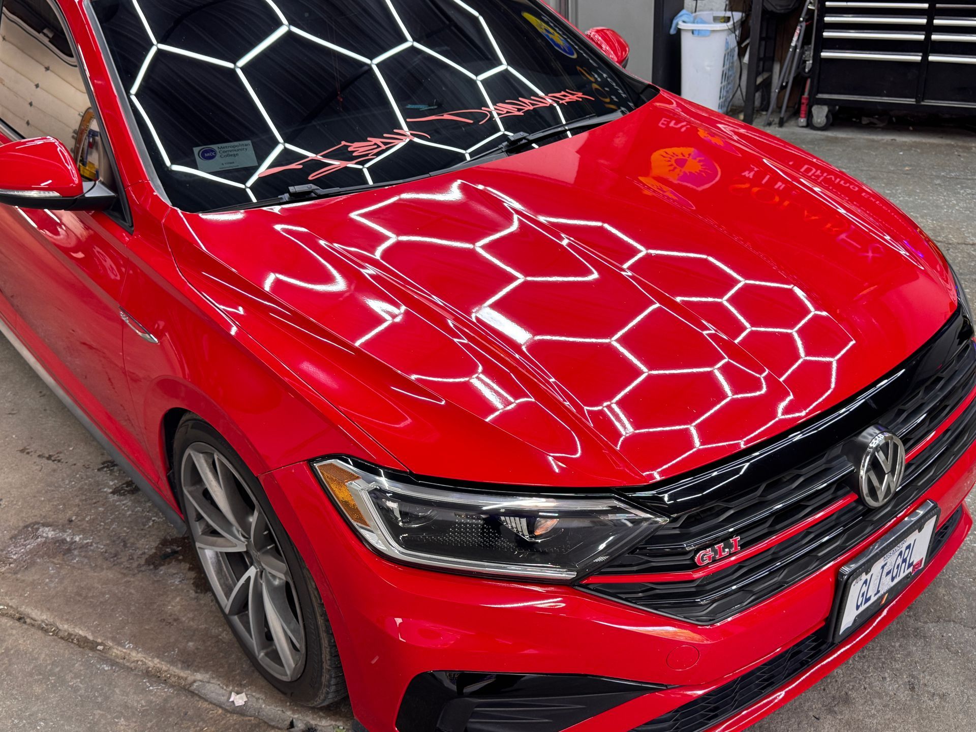 Red Volkswagen Jetta GLI with front-end paint protection film installed at Kearney Auto Restyling in