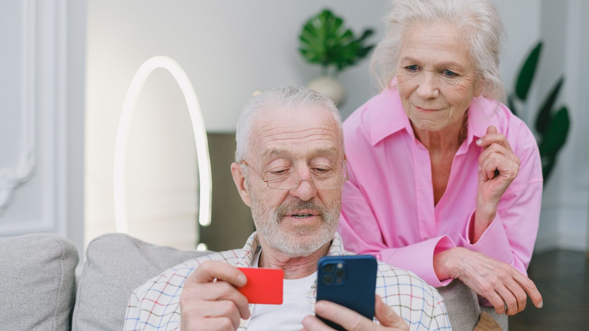 Couple paying rent online using cellphone