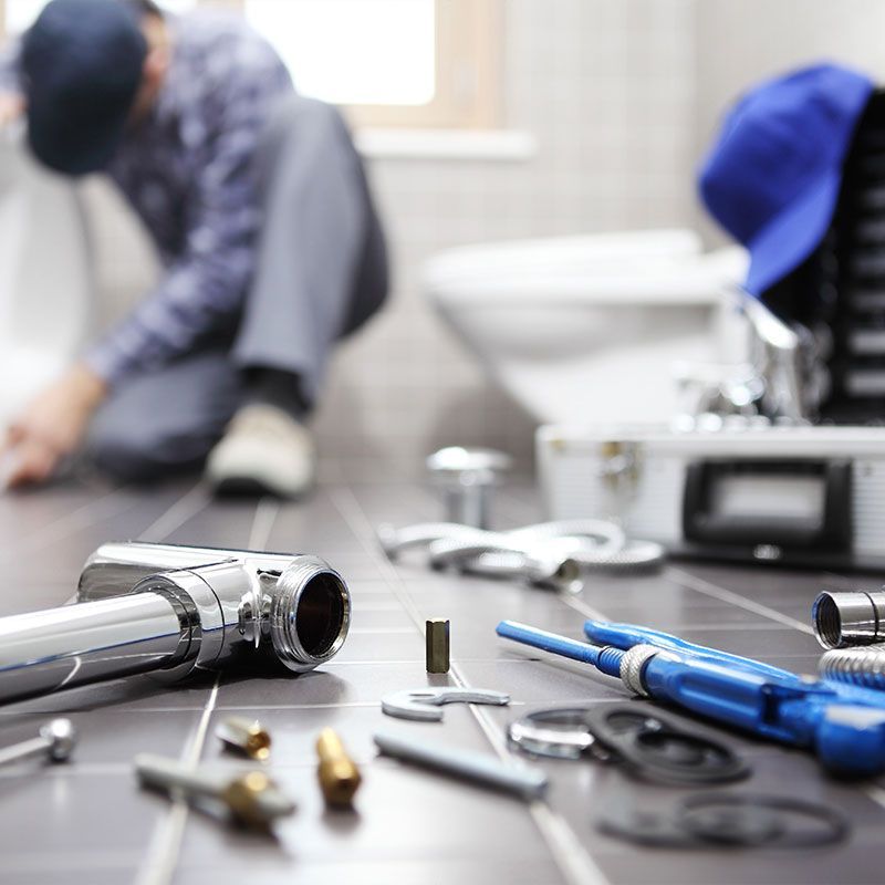 plumber at work in a bathroom, plumbing repair service, assemble and install concept