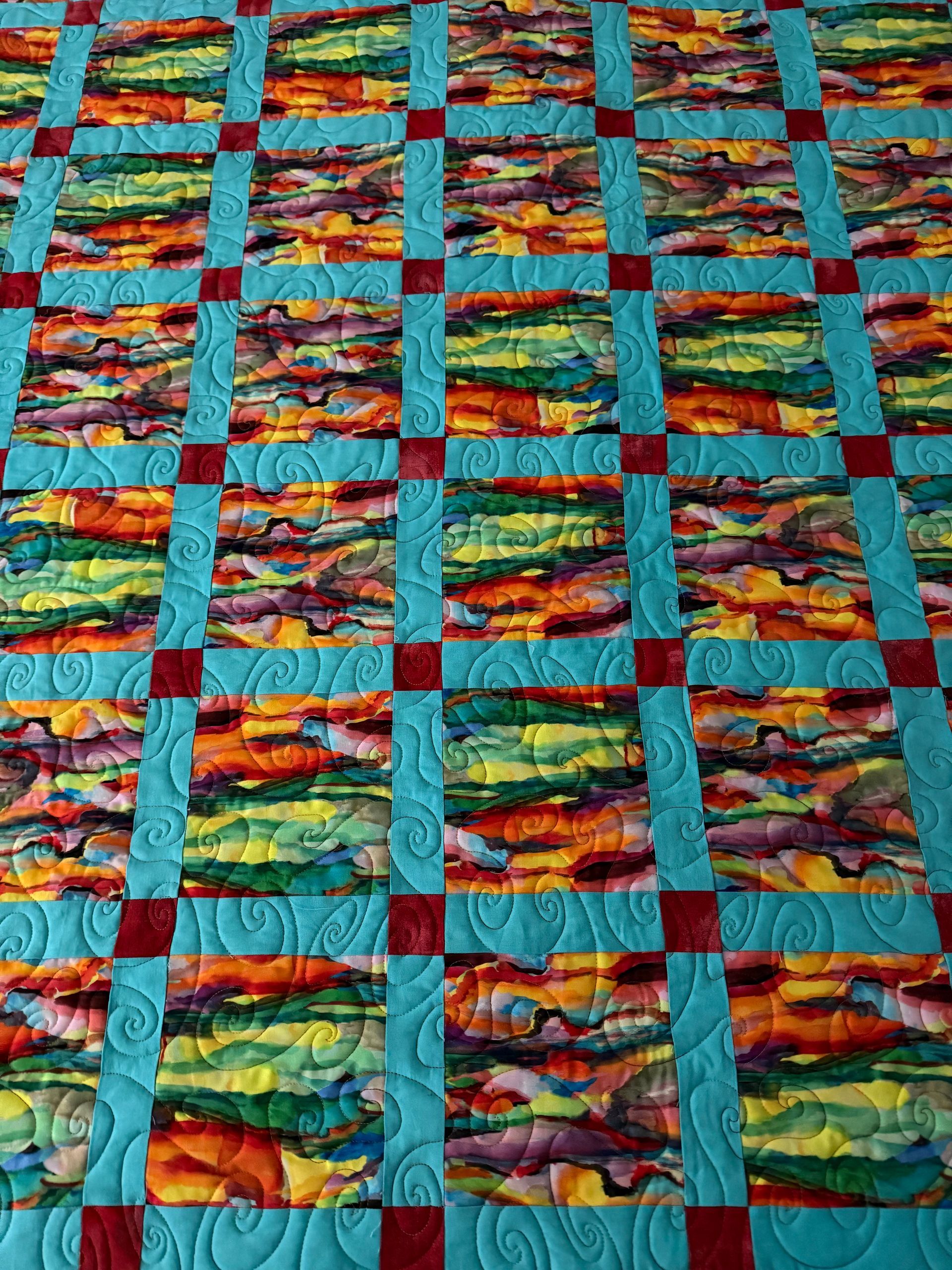 Quilt with vibrant, abstract blocks, teal sashing, and red cornerstones — Morning Star Quilting in Bateau Bay, NSW