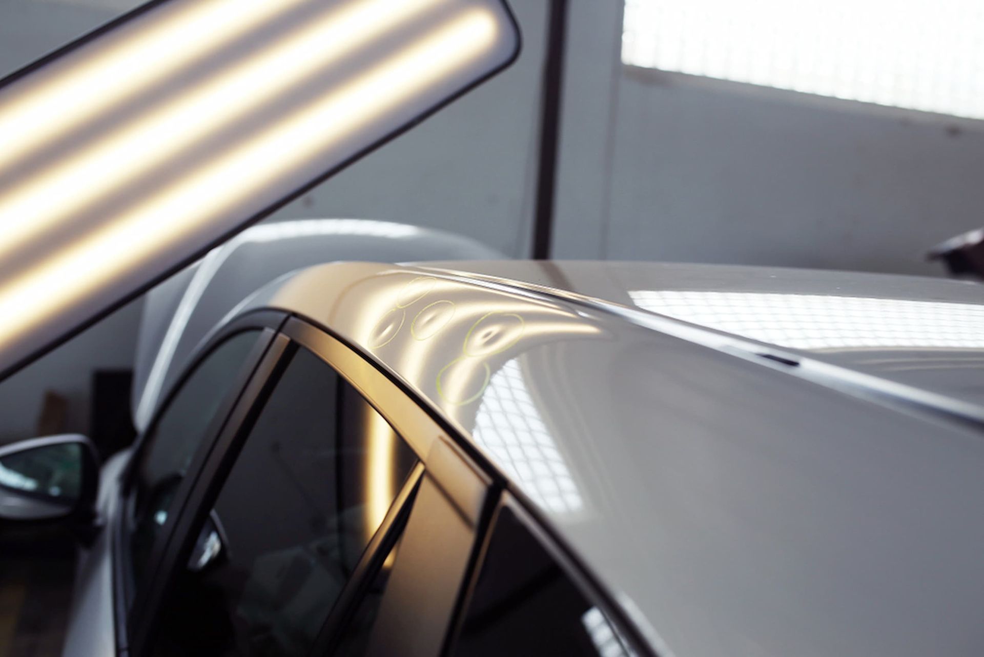 A Silver Car Is Being Repaired In A Garage — Chinderah Smash Repairs in Chinderah, NSW