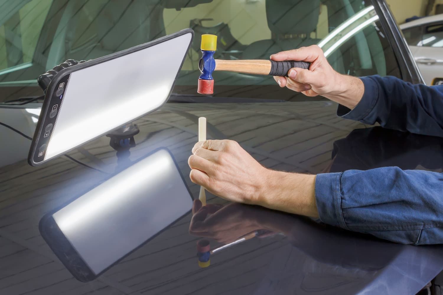 A Person Is Using a Hammer to Fix a Dent on A Car — Chinderah Smash Repairs in Chinderah, NSW