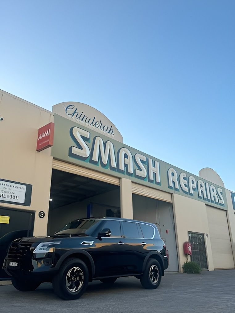 A Black SUV Is Parked in Front of A Building that Says Smash Repairs — Chinderah Smash Repairs in Chinderah, NSW