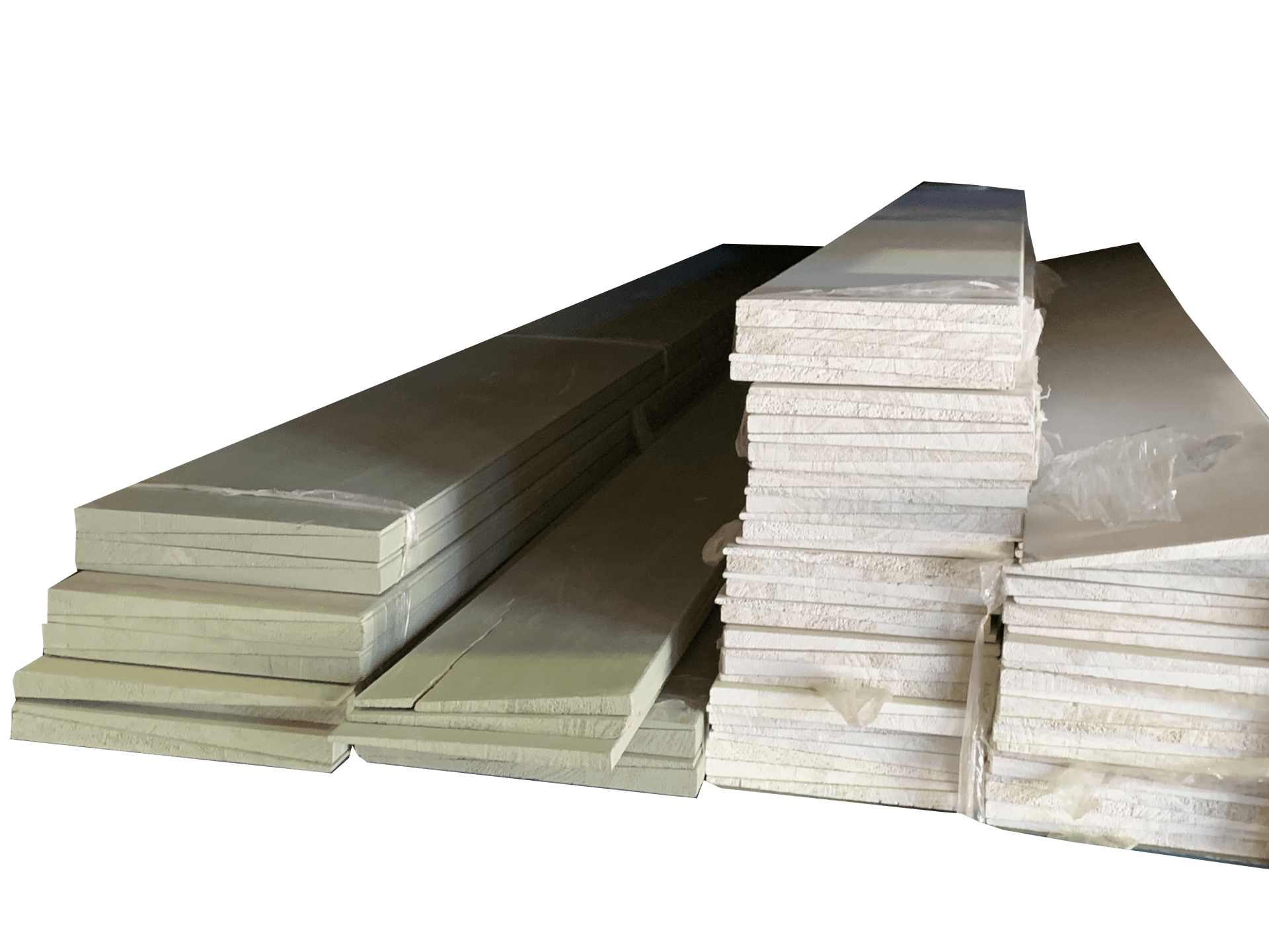 Stacks of rectangular building materials, likely insulation boards, wrapped in plastic.