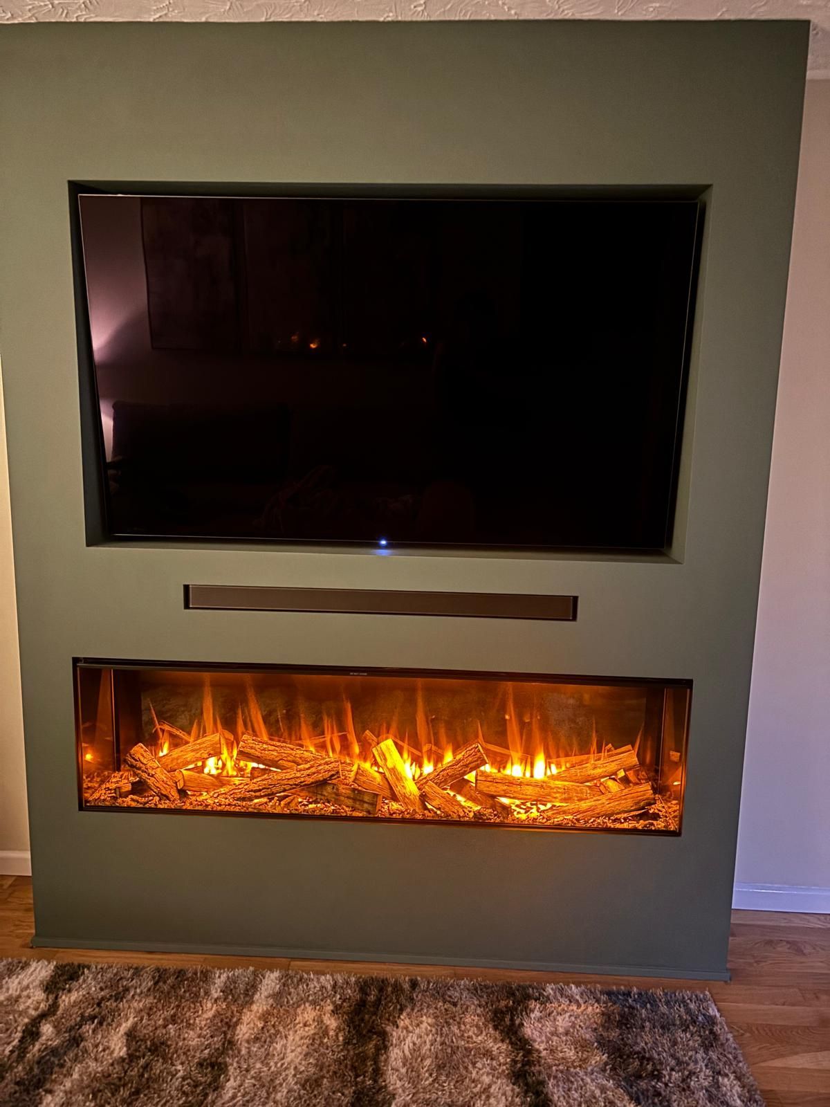 modern electric fire in a simple green media wall