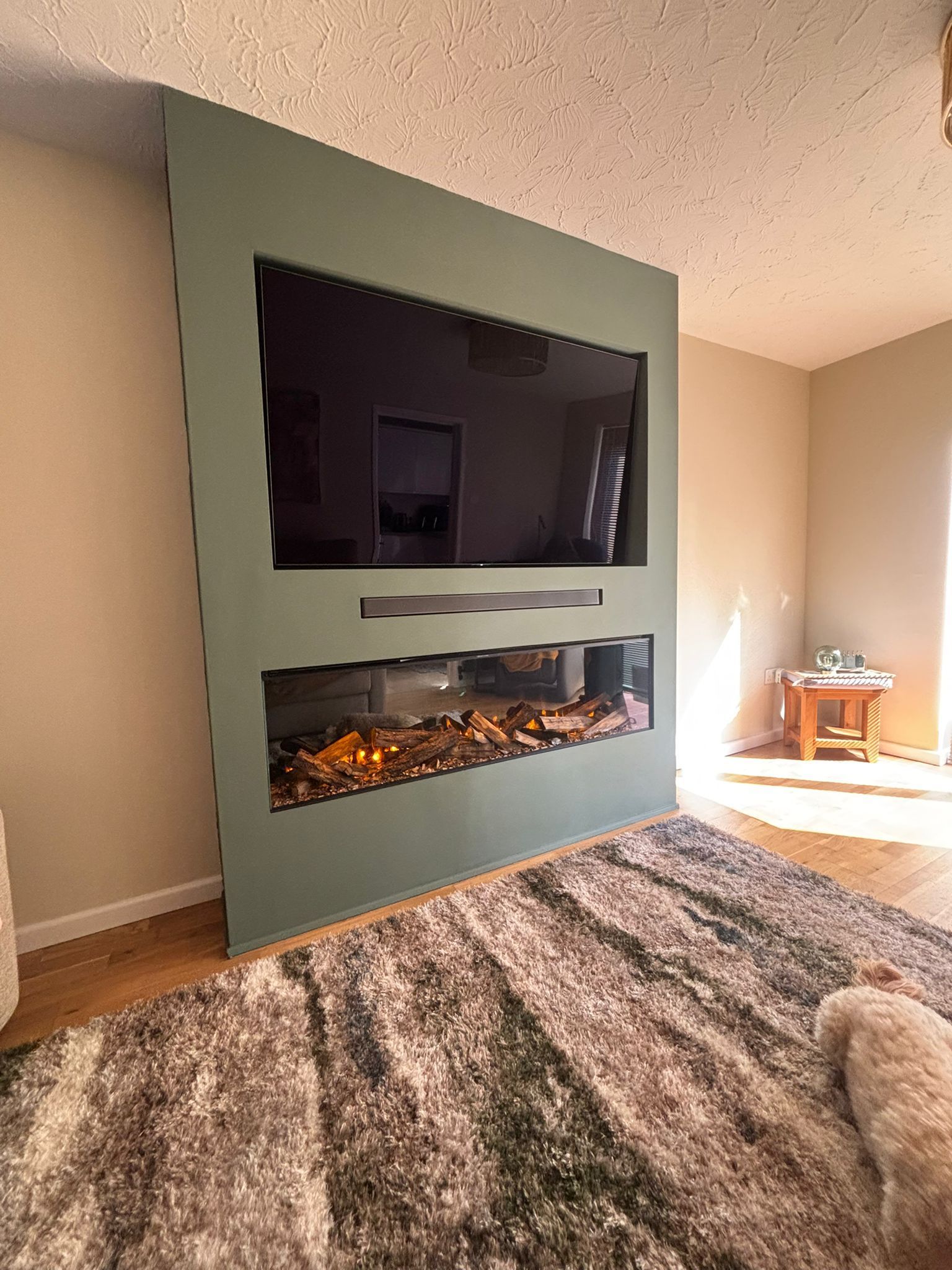 new forest 1600 electric fire in a green media wall