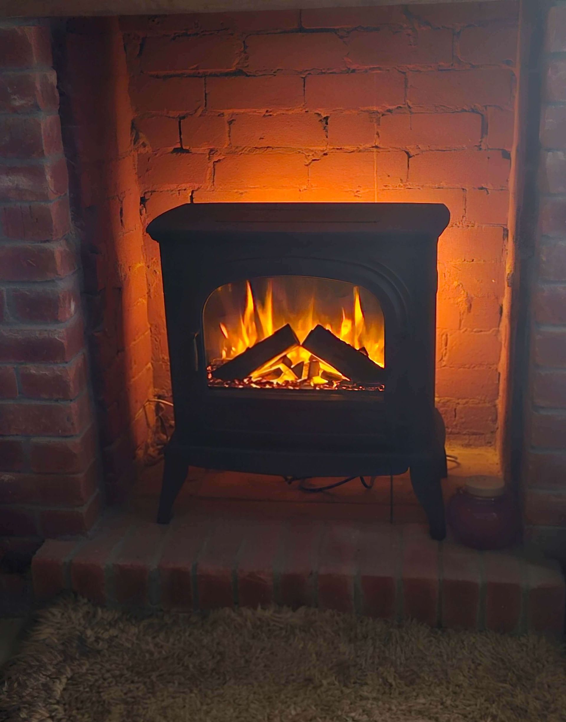 electric stove in existing fireplace
