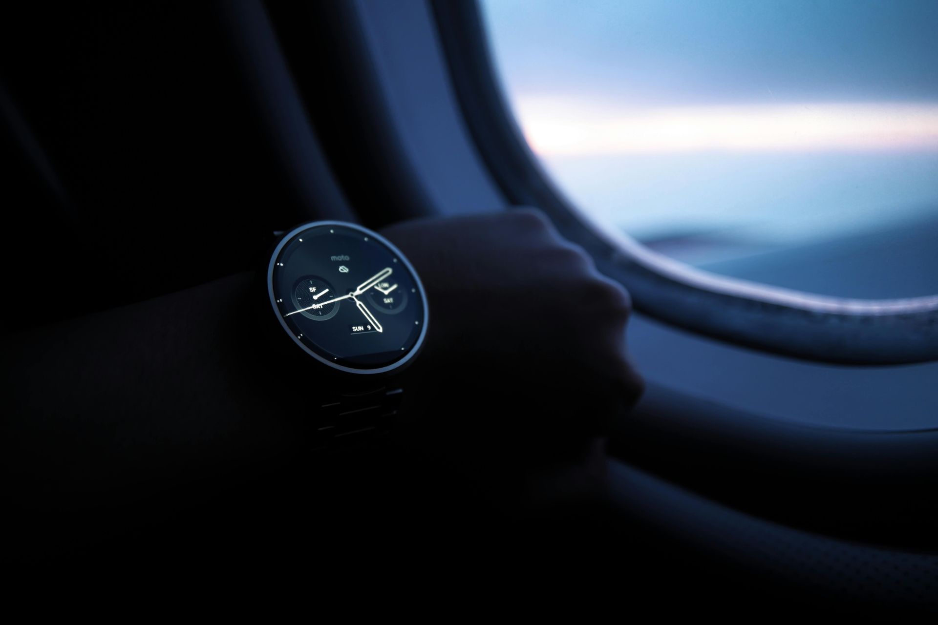 A person wearing a watch with a dragonfly on it