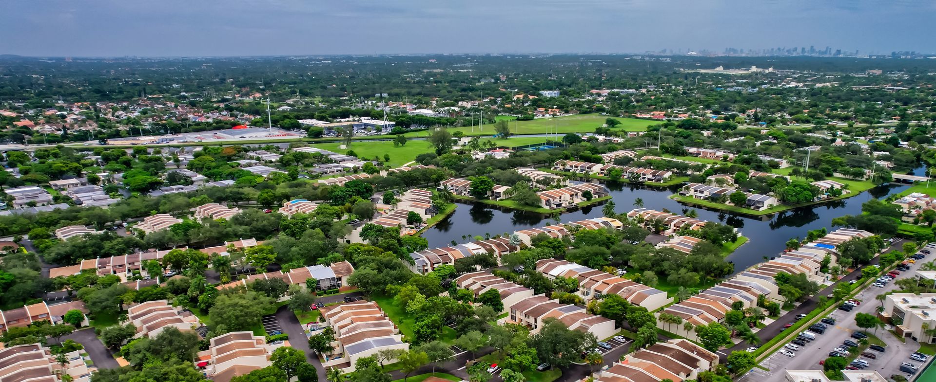 An aerial view of a residential area with a river running through it.