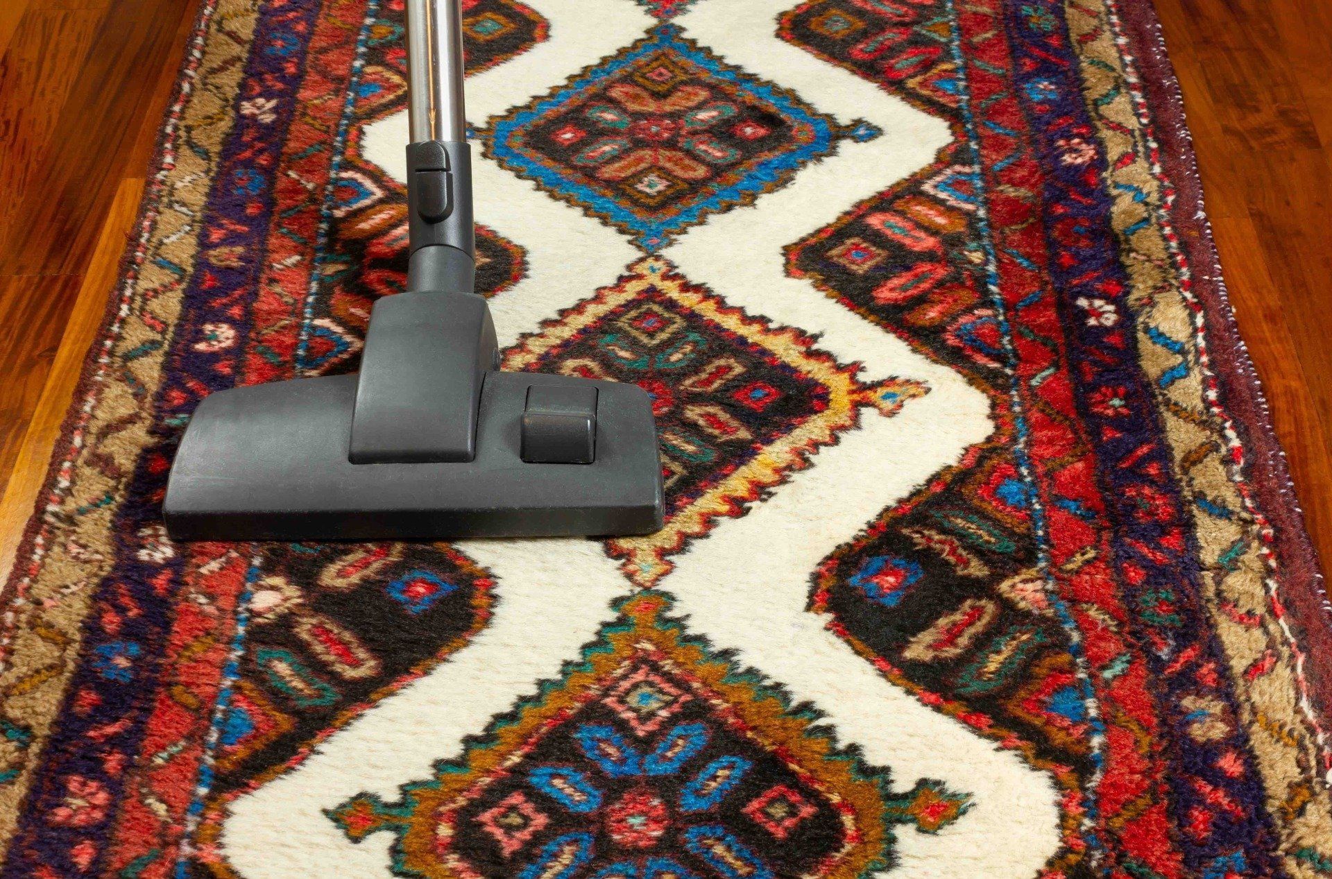 a person using vacuum cleaner to dry clean the carpet