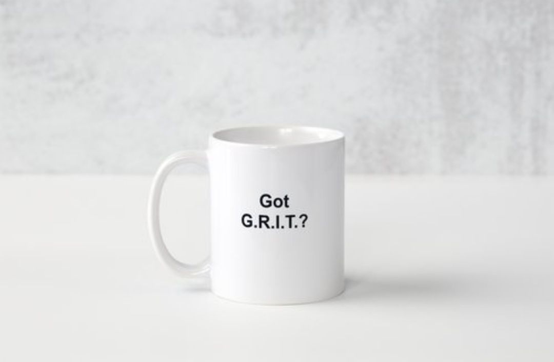 A white coffee mug with the words `` got grit '' written on it