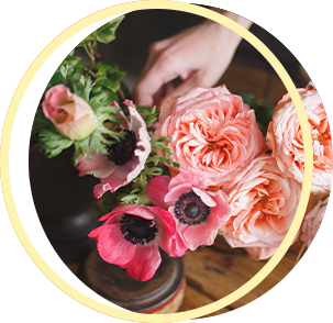 A person is arranging flowers in a vase on a table. A person is arranging flowers in a vase on a table.