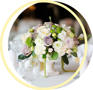 A vase filled with flowers is on a table. A vase filled with flowers is on a table.