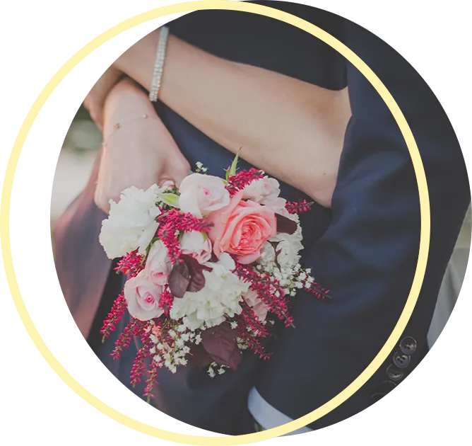 A bride and groom are hugging and the bride is holding a bouquet of flowers. A bride and groom are hugging and the bride is holding a bouquet of flowers.
