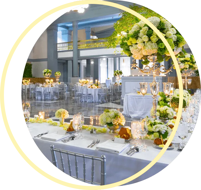 A large room with tables and chairs set up for a wedding reception. A large room with tables and chairs set up for a wedding reception.