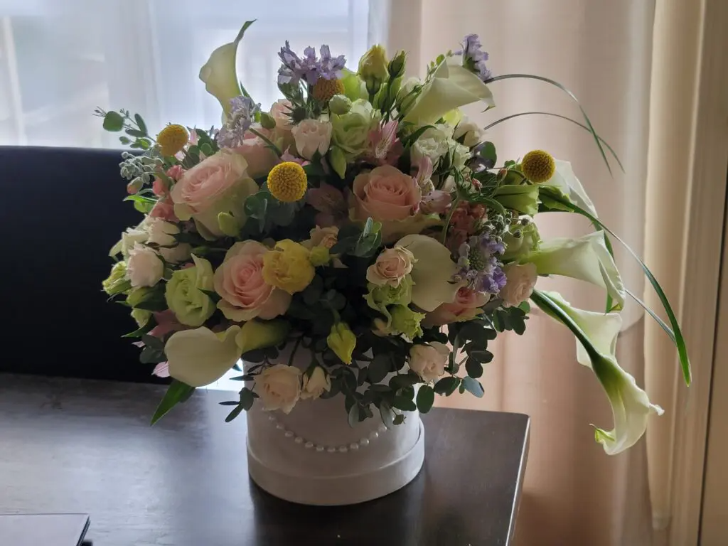 A vase filled with flowers is sitting on a table.