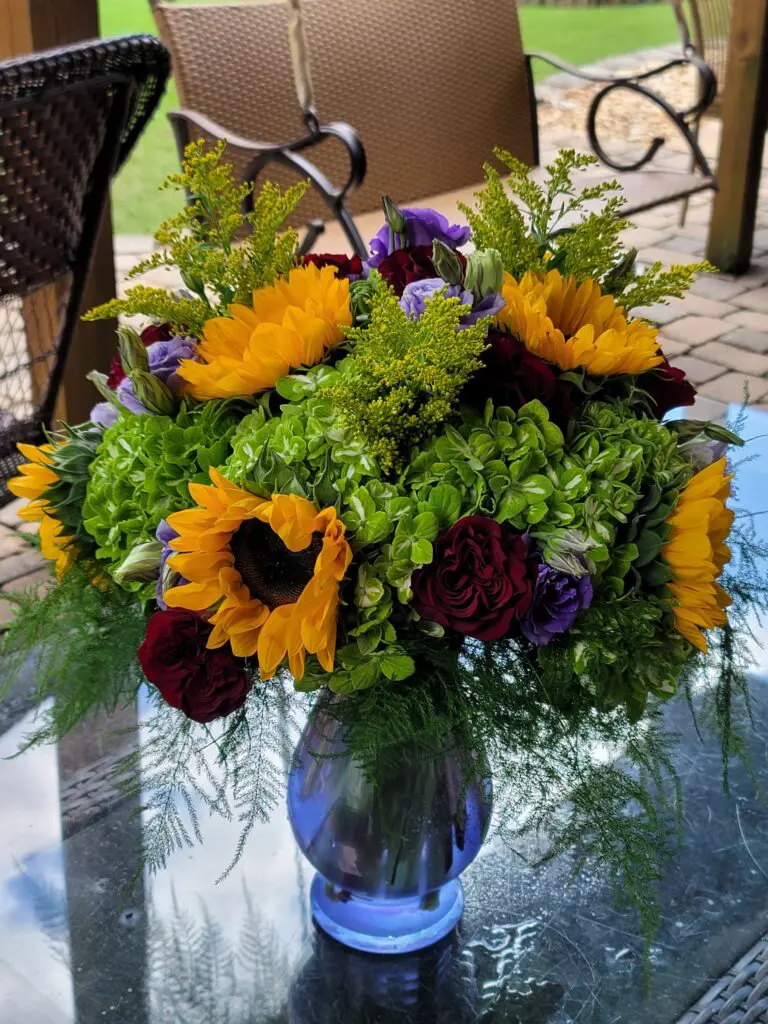 A vase filled with flowers is sitting on a table.