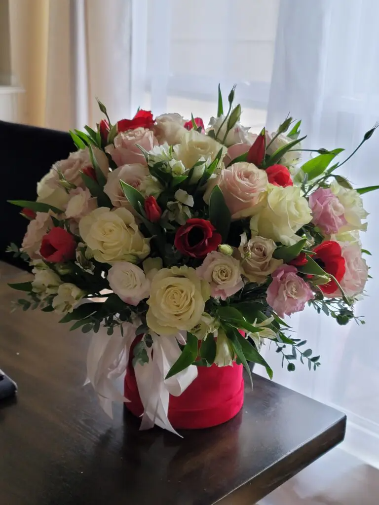 A vase filled with flowers is sitting on a table.