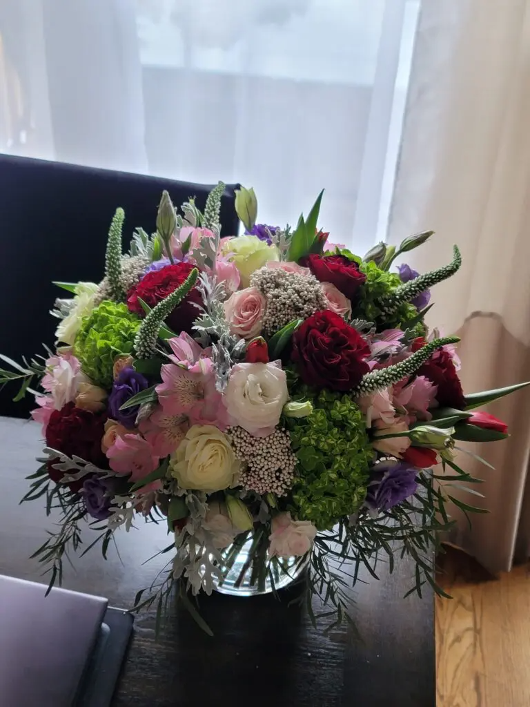 A vase filled with flowers is sitting on a table.