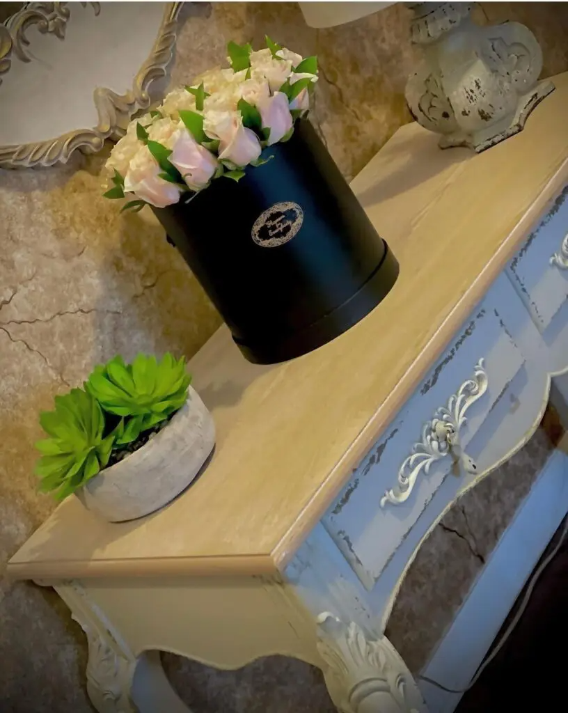 A table with a black box of flowers on it