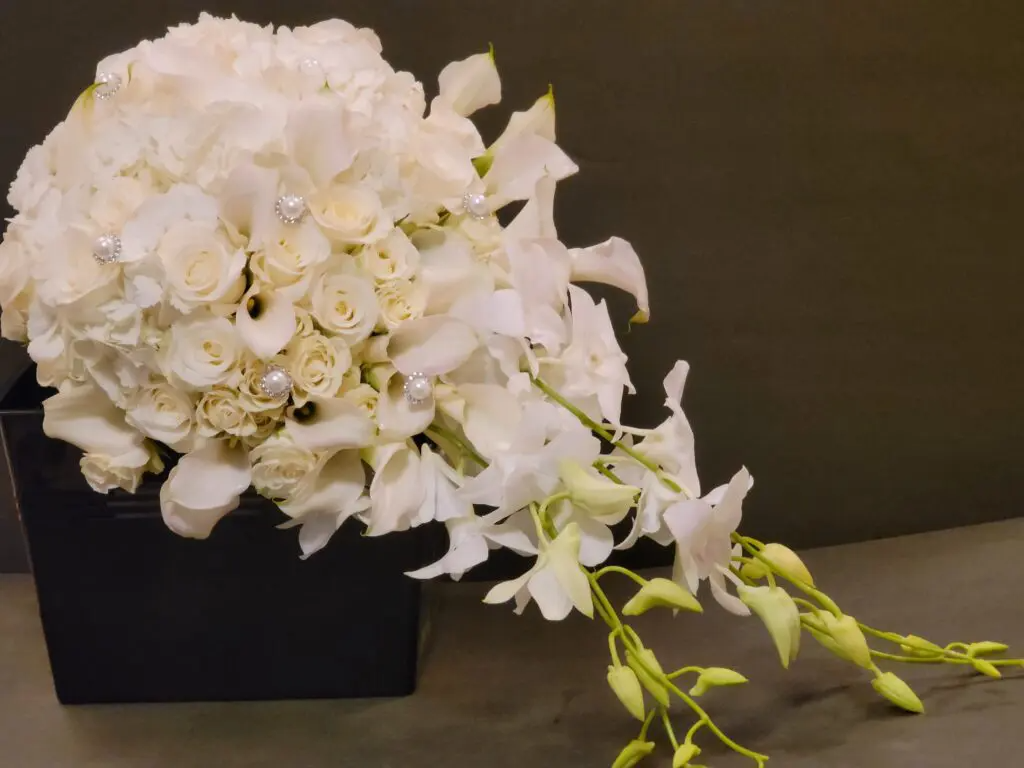 A bouquet of white flowers in a black box