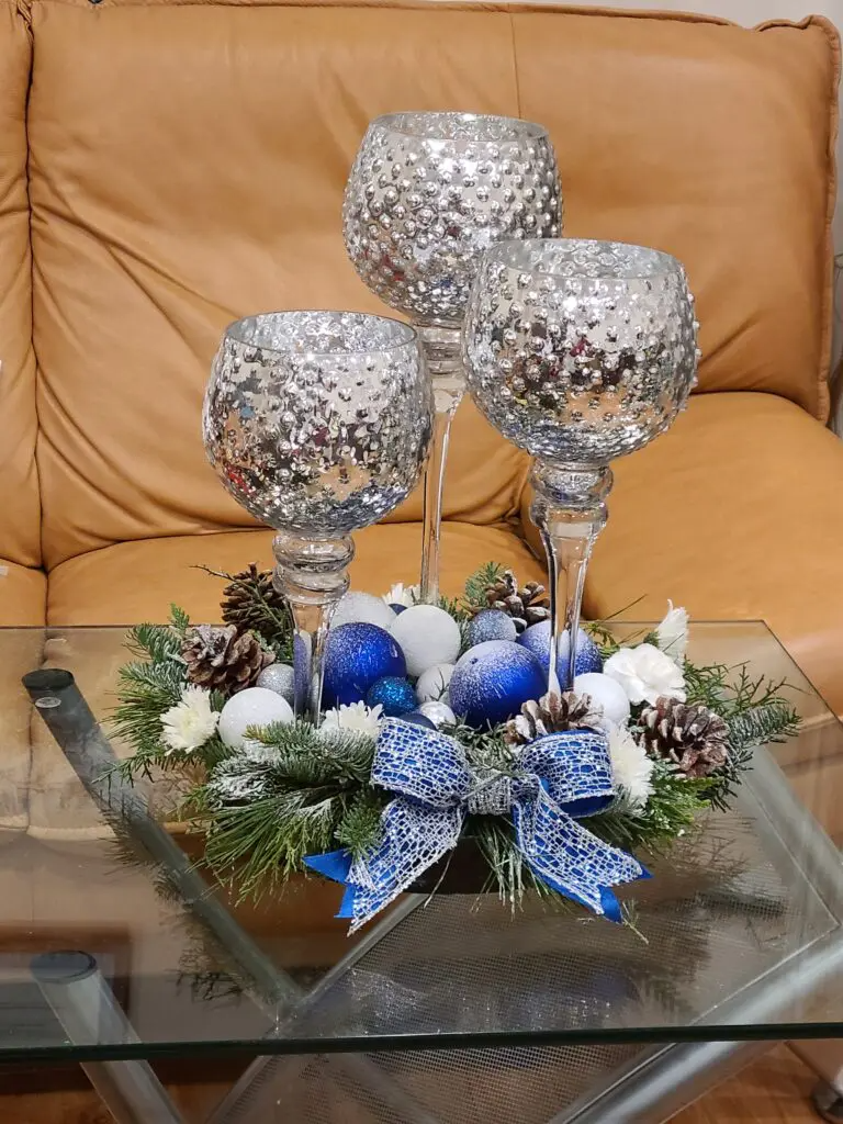A glass table with a christmas centerpiece on it