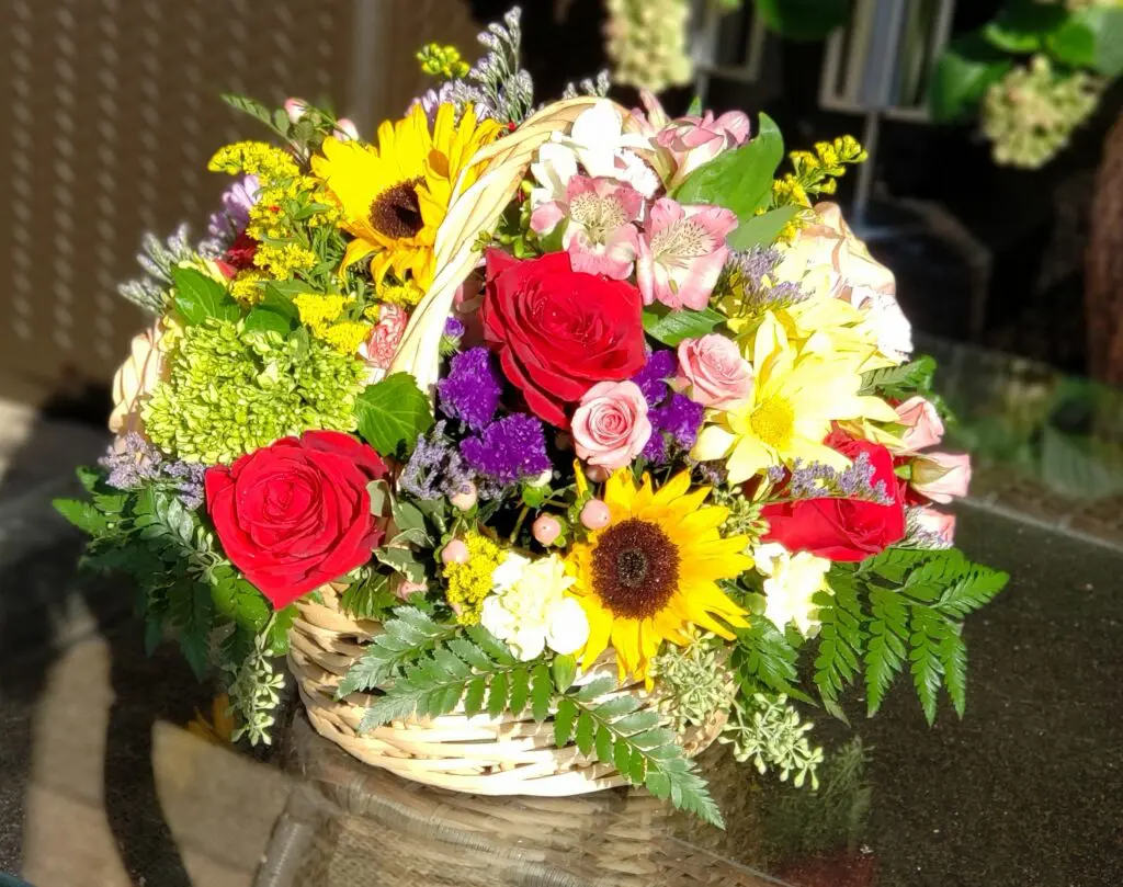 A basket filled with flowers is sitting on a table.