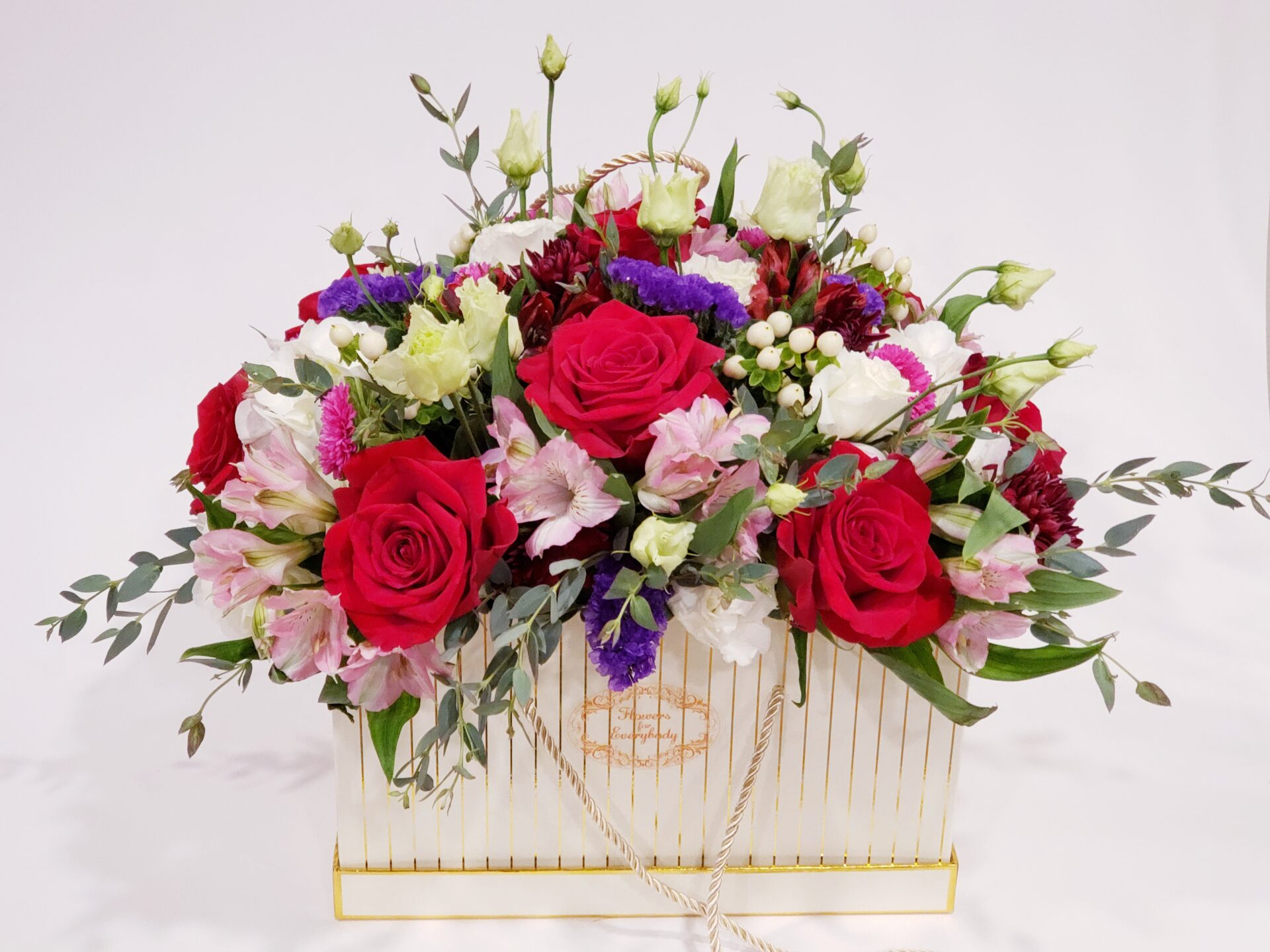 There are many different types of flowers in the basket.
