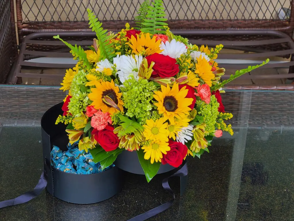 A bouquet of flowers in a black box on a table