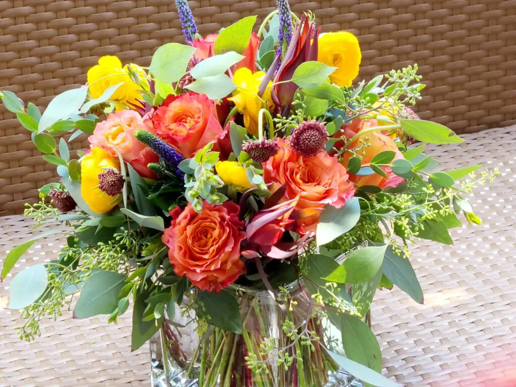 A vase filled with flowers is sitting on a table.