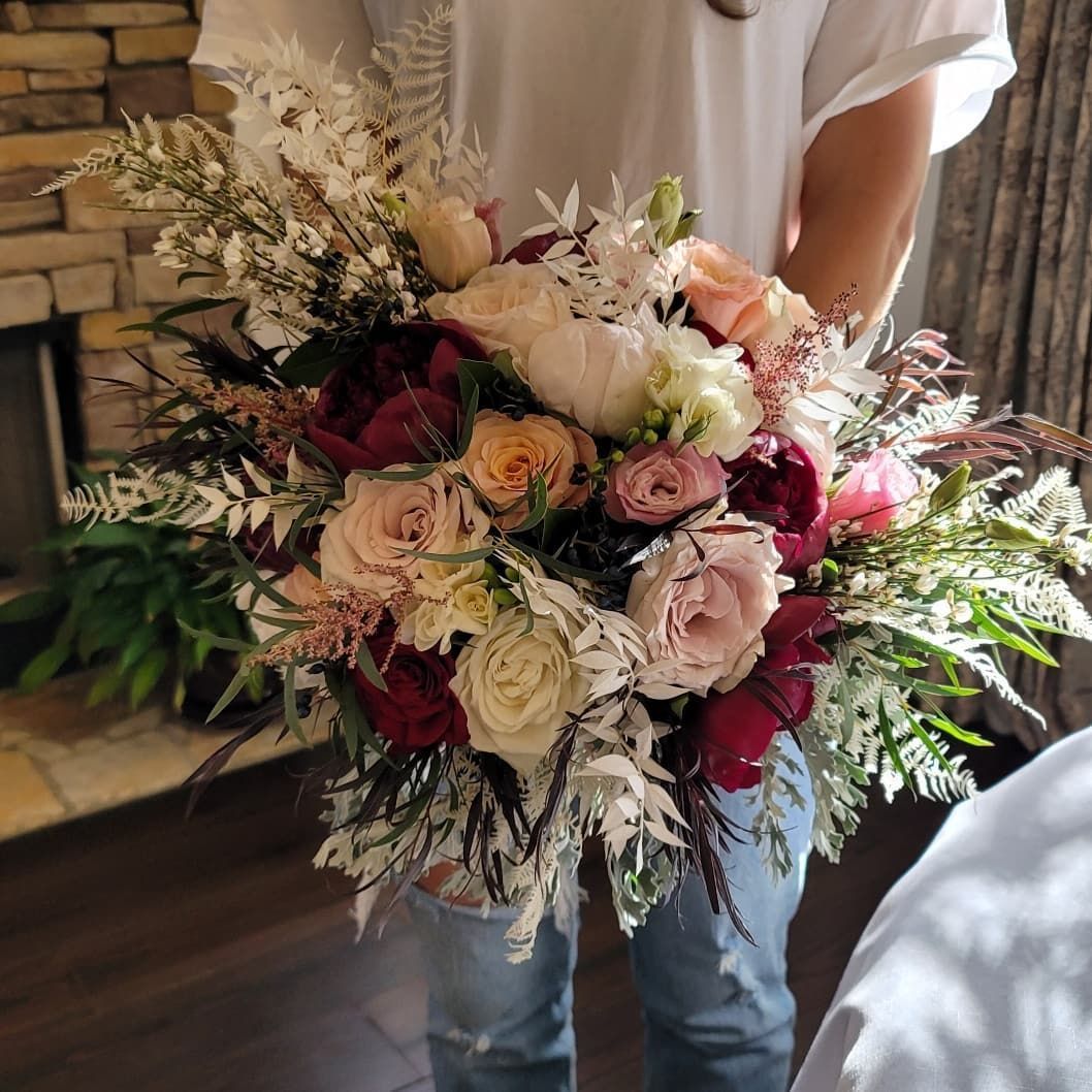 A person is holding a bouquet of flowers in their hands.