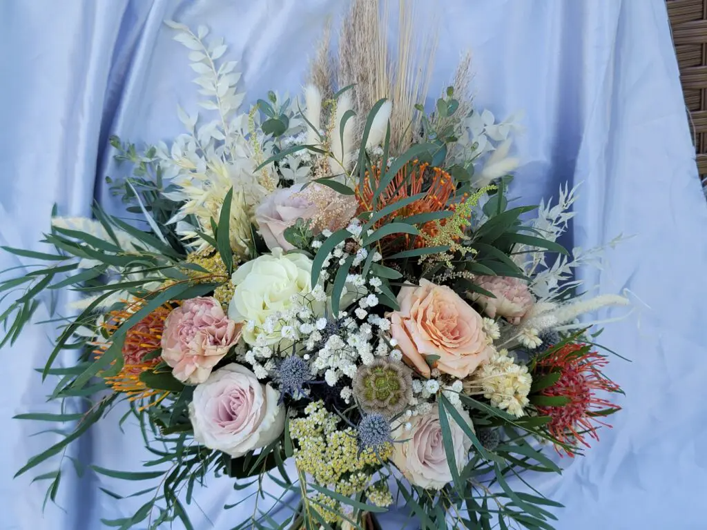A close up of a bouquet of flowers on a table.