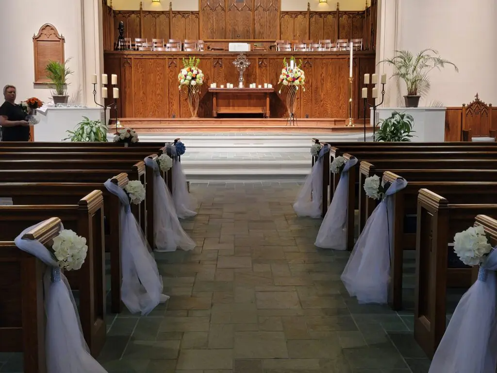 The inside of a church decorated for a wedding ceremony