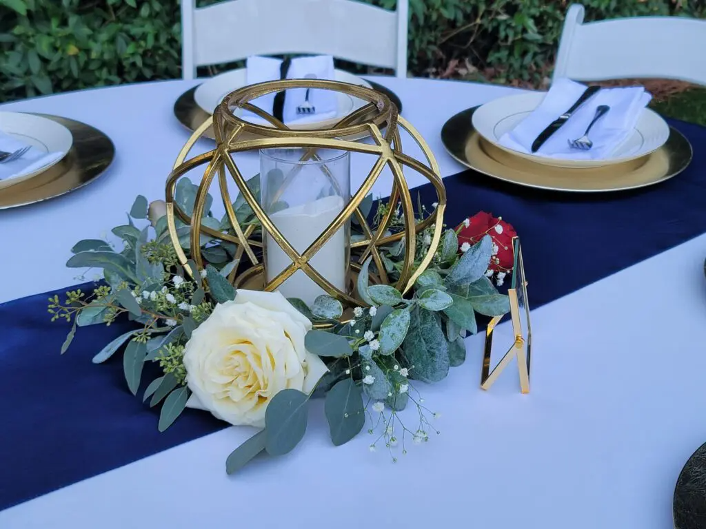 A table with plates , napkins , and a candle on it.