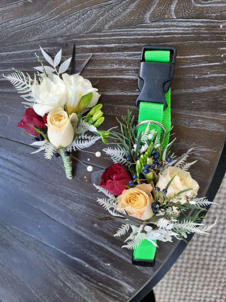 A dog collar with flowers on it is sitting on a wooden table.