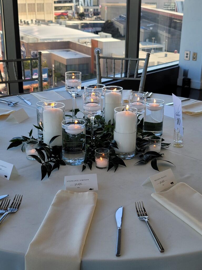 A table set for a wedding reception with candles and flowers