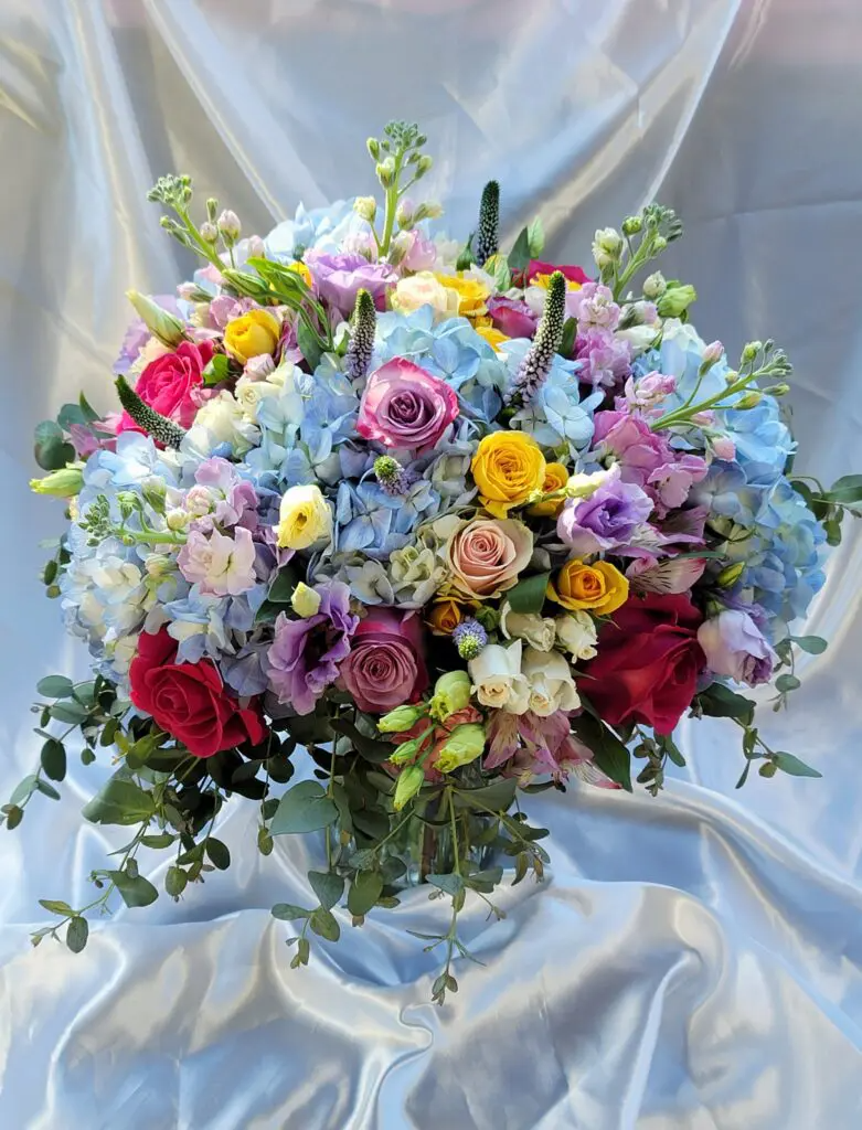 A large bouquet of colorful flowers is sitting on a table.