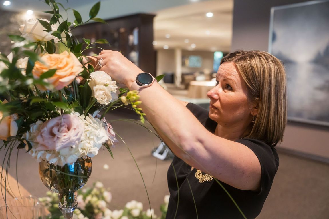 Lana setting up the flower arrangements.