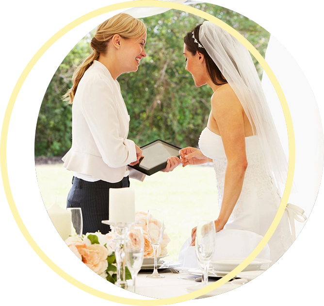 A woman is holding a tablet next to a bride A woman is holding a tablet next to a bride