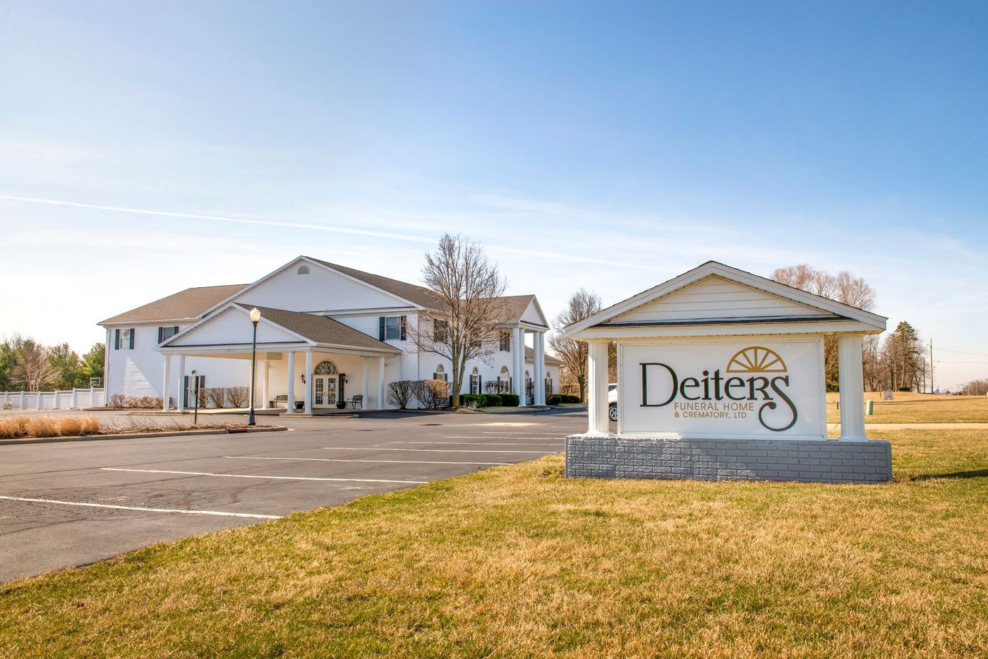 White Deiters Funeral Home building and sign on a sunny day.