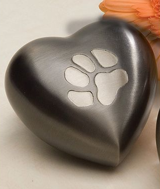 Heart-shaped pet urn with a recessed paw print, silver finish.