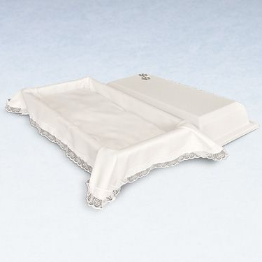 White baby changing table with draped cloth edged in gray lace.