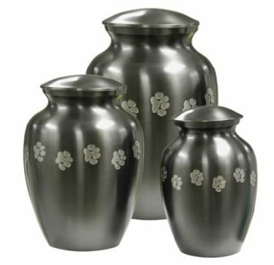 Three brushed-metal urns of varying sizes, each adorned with floral patterns.